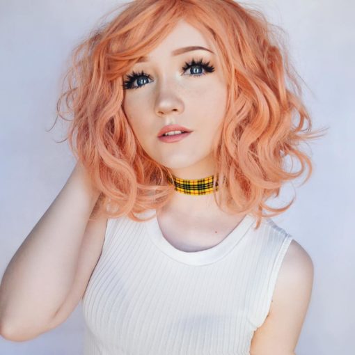 A bob styled in loose waves with lots of volume. Peach Tea is a blend of pastel peach and baby pink colour from roots to tips. A light wispy fringe can be styled to suit your look.