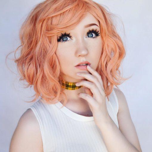A bob styled in loose waves with lots of volume. Peach Tea is a blend of pastel peach and baby pink colour from roots to tips. A light wispy fringe can be styled to suit your look.
