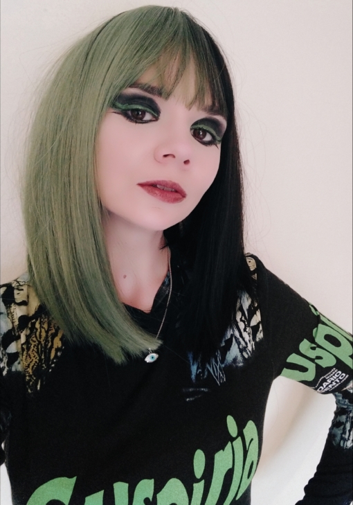 Serpentine takes on the dramatic colour divide. A sleek straight bob (lob) of jade green and dark brown colours. Split down the centre parting and carrying the colour through the blunt fringe. 