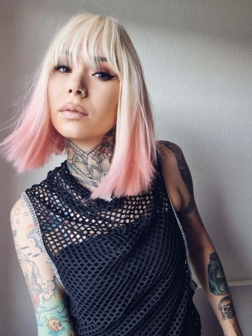 Candy pop has blonde roots that run into a pastel pink ombre. A blunt cut styled dead straight with a full fringe.