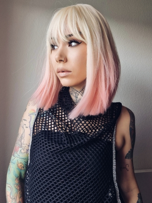 Candy pop has blonde roots that run into a pastel pink ombre. A blunt cut styled dead straight with a full fringe.