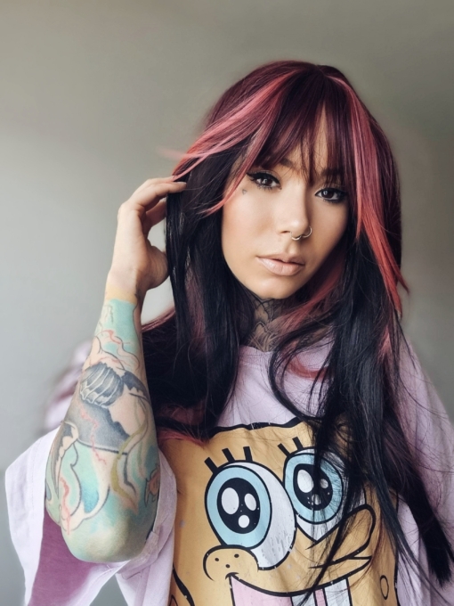 Stitch is cut into the hime style with blunt bangs. Sleek and long with a mix of dark pink and black. With a block of colour from the nape of the neck, to give a peek-a-boo effect.