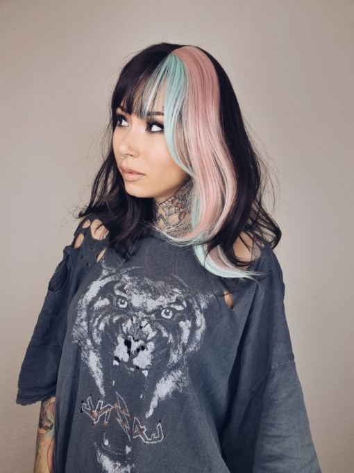 This vivid and bright wig has a natural twist of dark brown and pastel pink and blue. Blocks of colour set the look for this sleek long bob (lob) with a light blunt fringe that carries the colour.